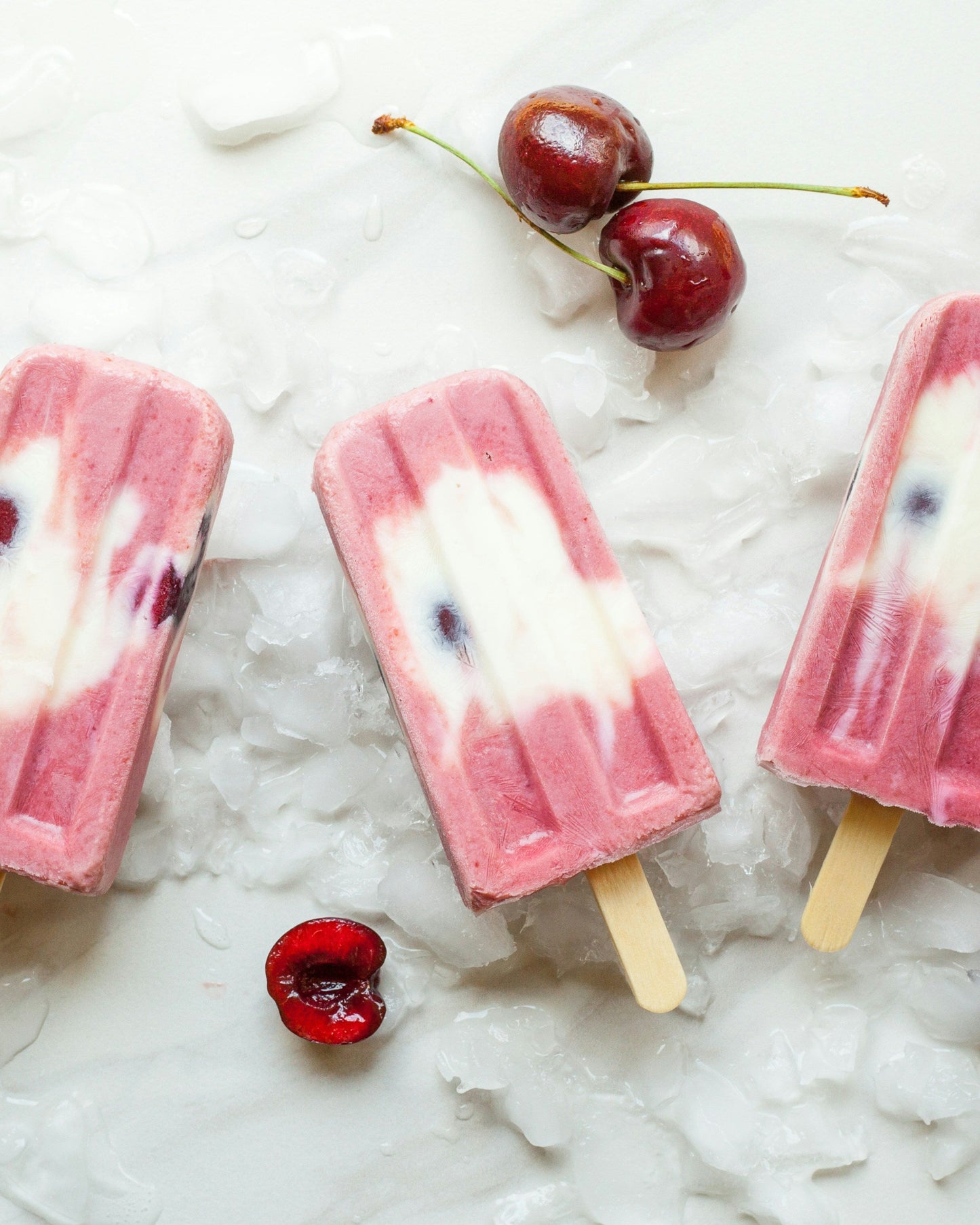 Strawberry popsicles on ice.