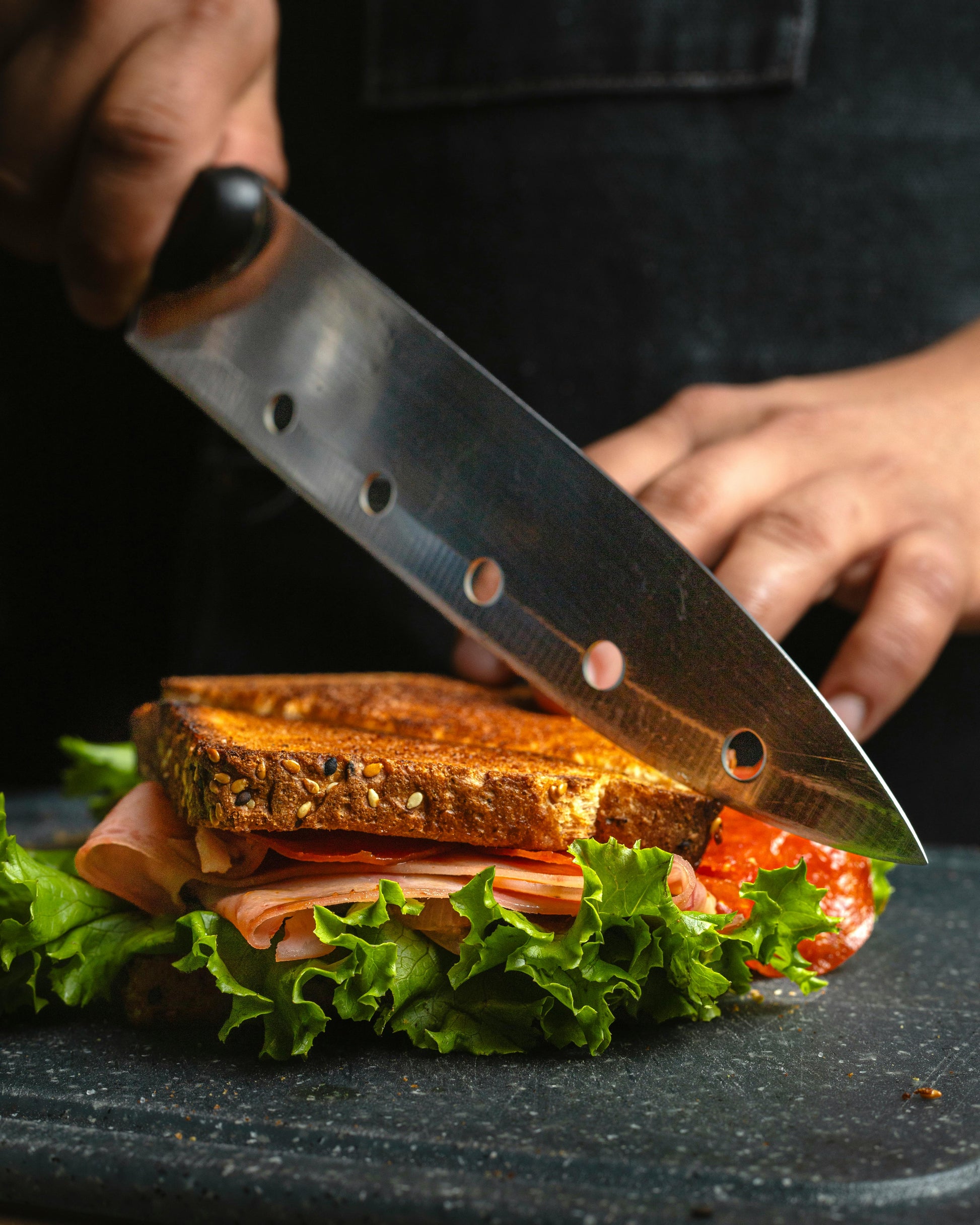 A sandwich being cut in half