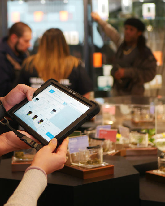 Person ordering from a point of sale system at a smoke shop.