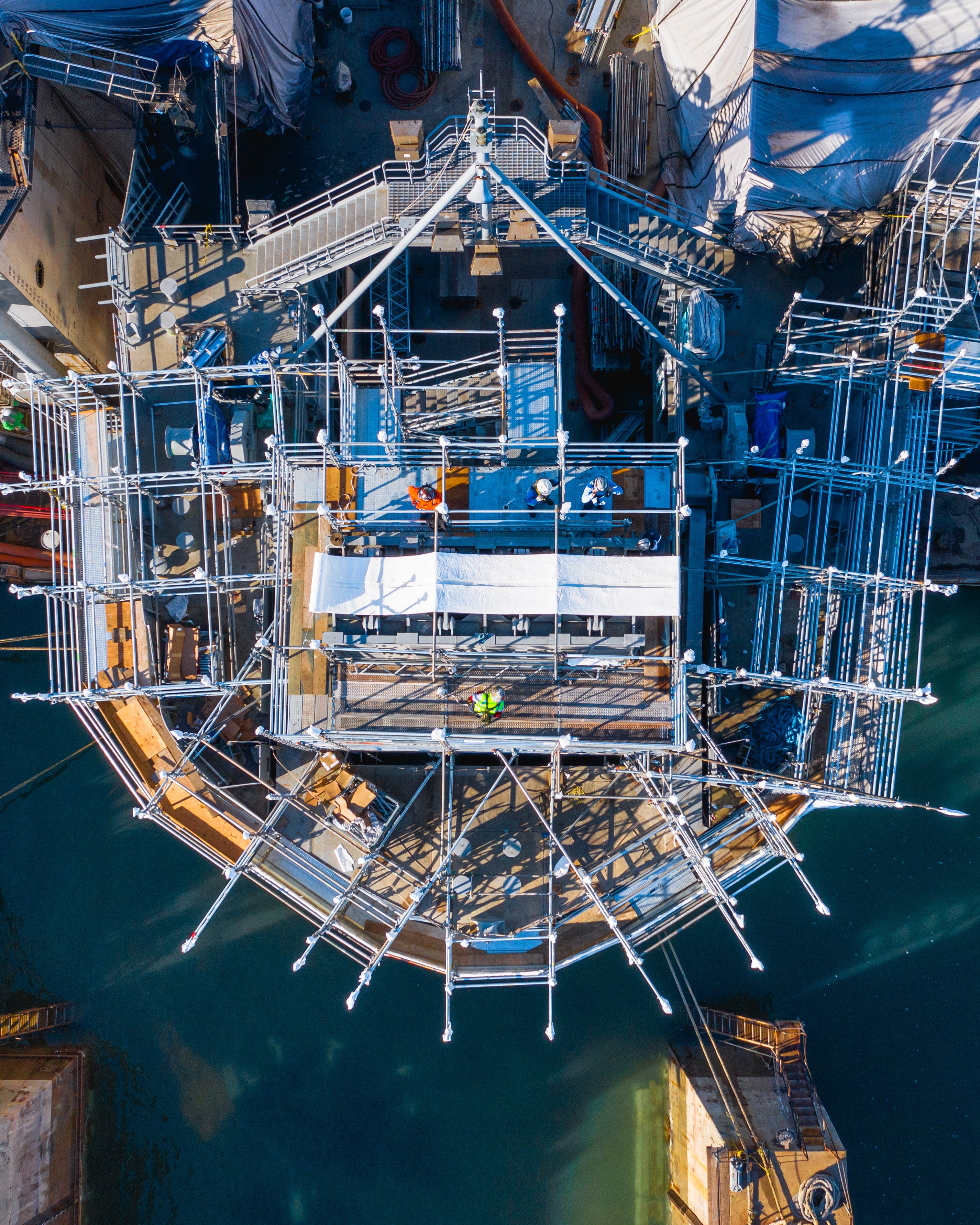 Top down view of construction being done on a ship.