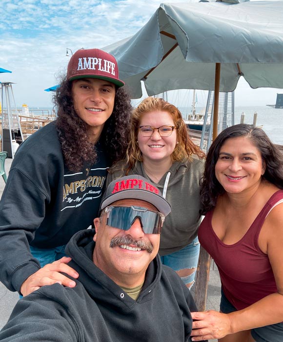 Selfie of Priscilla Nevarez and her family, Abdul Nevarez, Armando Nevarez, and Alesandra Barros at a coastal restaurant 