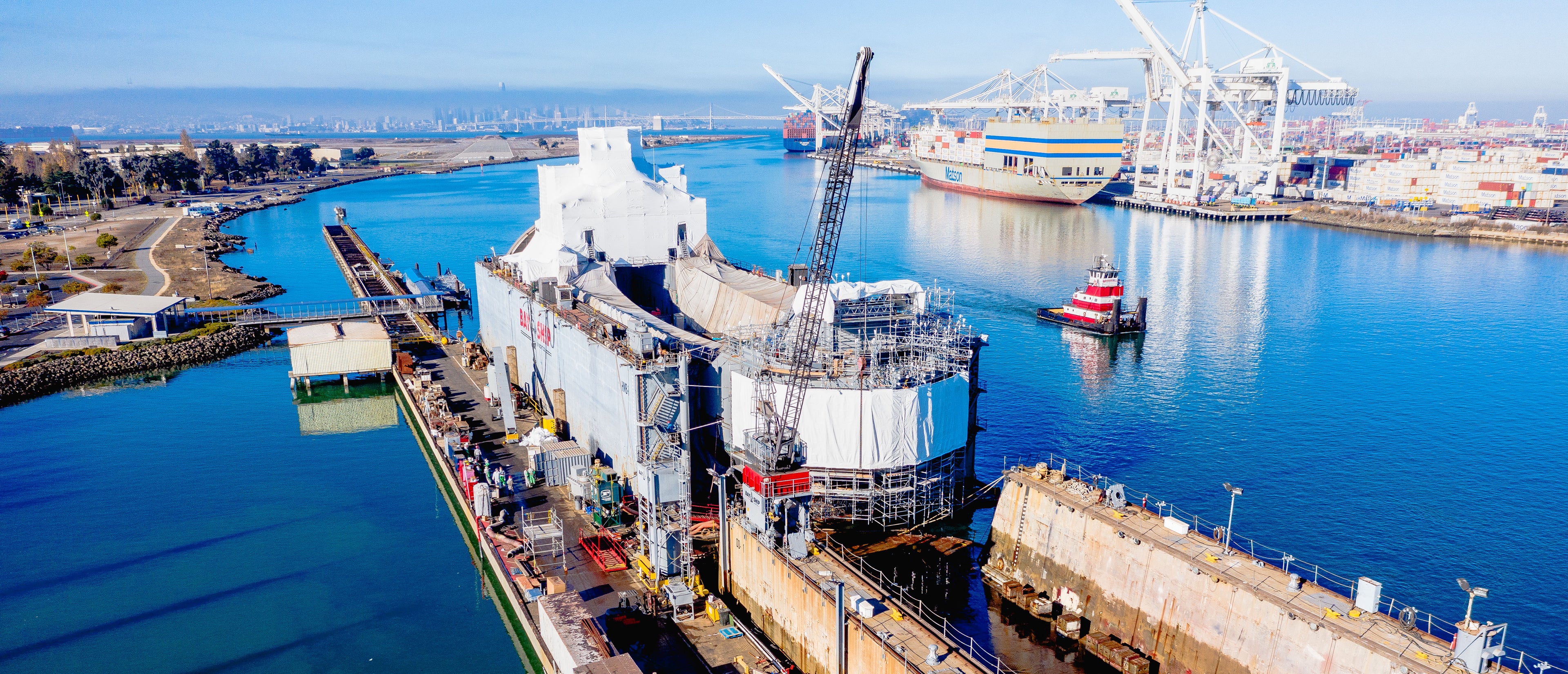 A bird's eye view of a ship with scaffolding surrounding it.