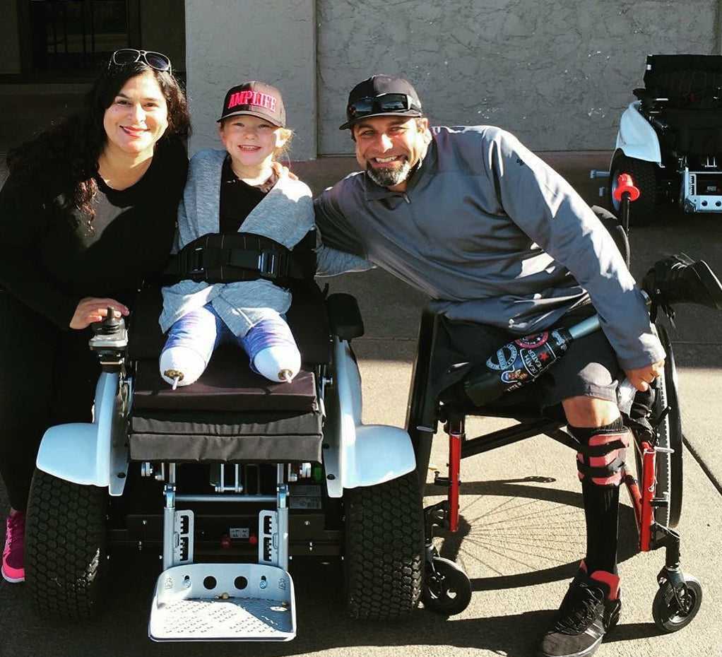 Priscilla Nevarez and Abdul Nevarez with a double above knee amputee child golfer.